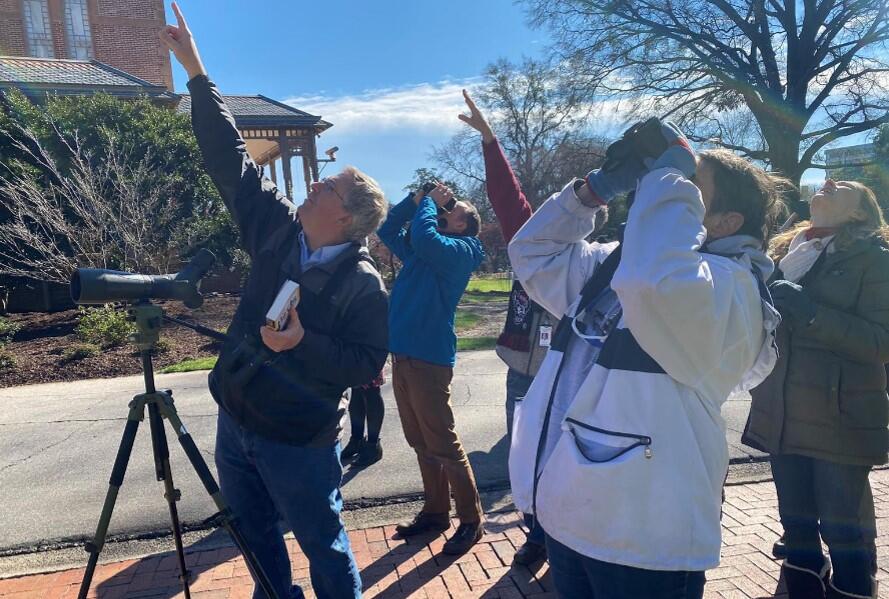 Audubon North Carolina Interim Executive Director Curtis Smalling points out birds to participants including First Lady Kristin Cooper.