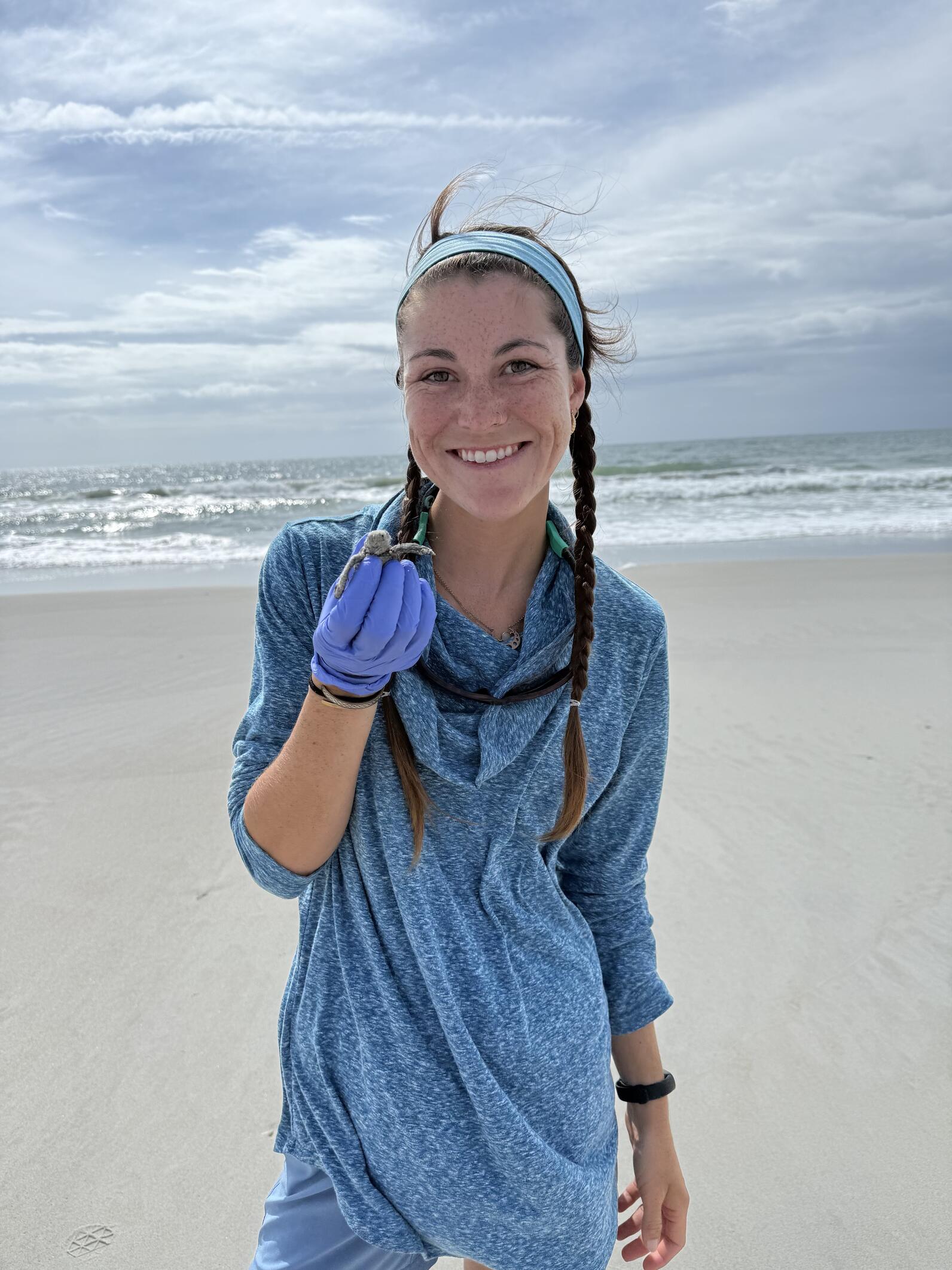 Ashlyn with a sea turtle hatchling. Photo: Ashlyn Newberry/Audubon