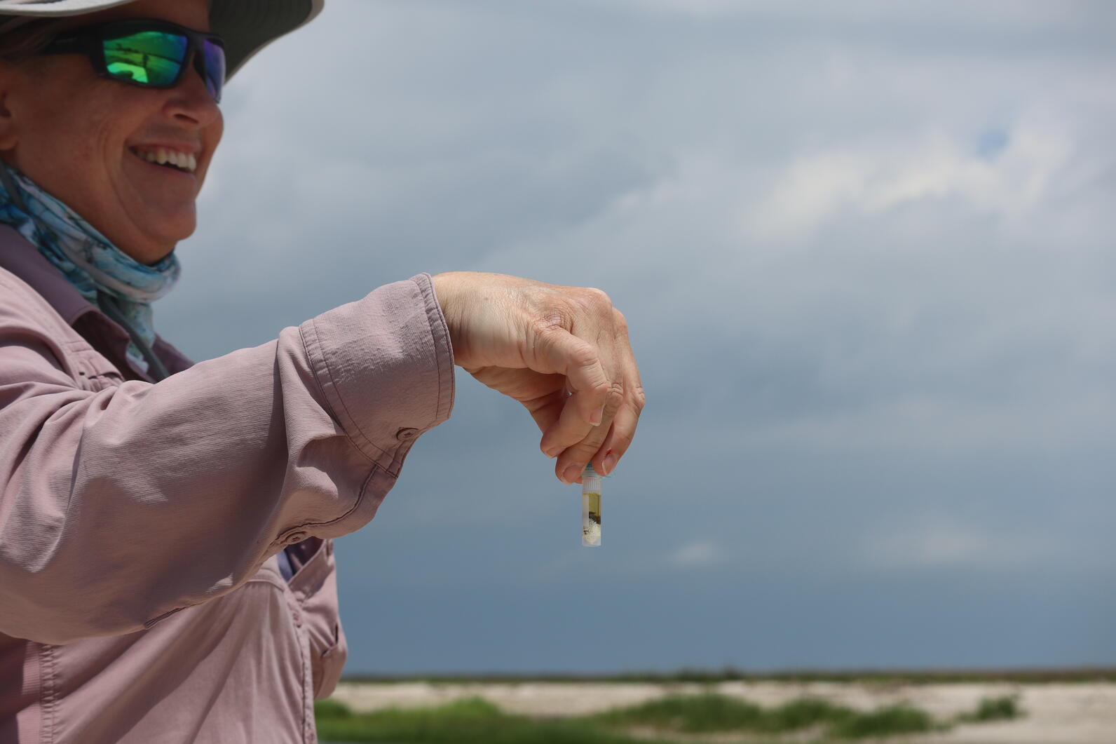 Researcher Dr. Kate Goodenough holding a poop sample collected from an American Oystercatcher chick after banding. Photo: Brittany Salmons/Audubon