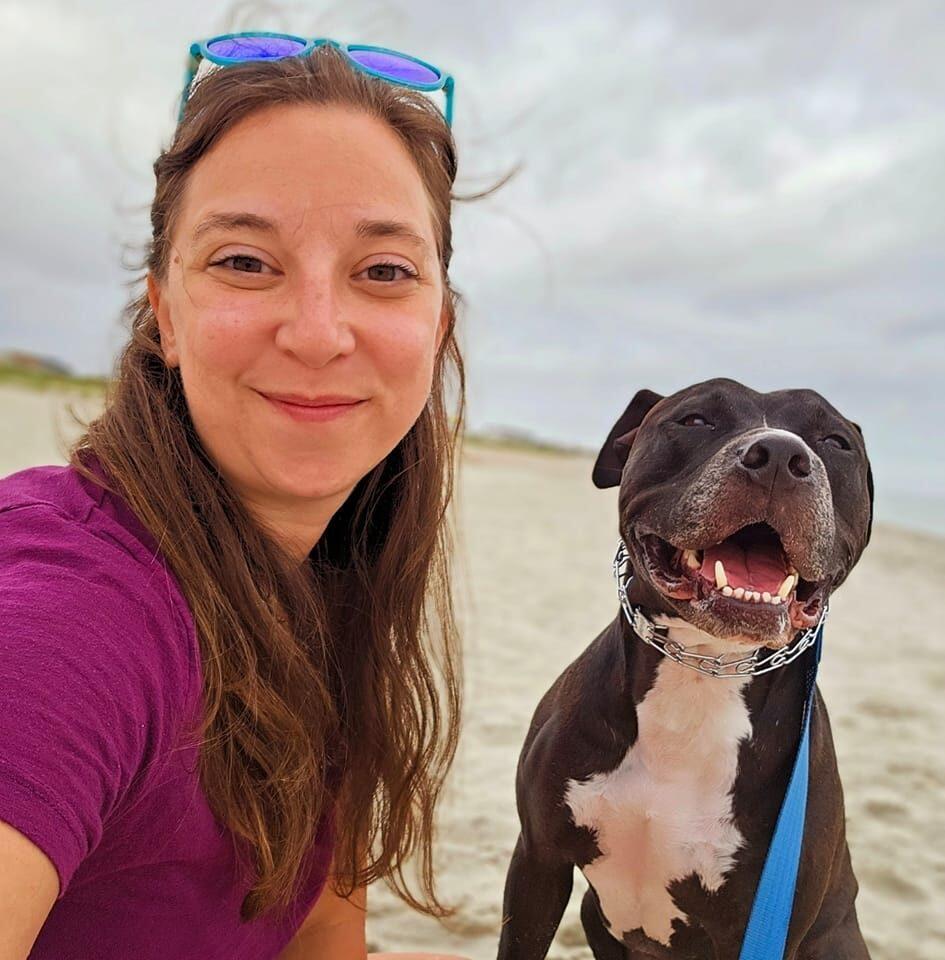 Sara and her dog River at the beach